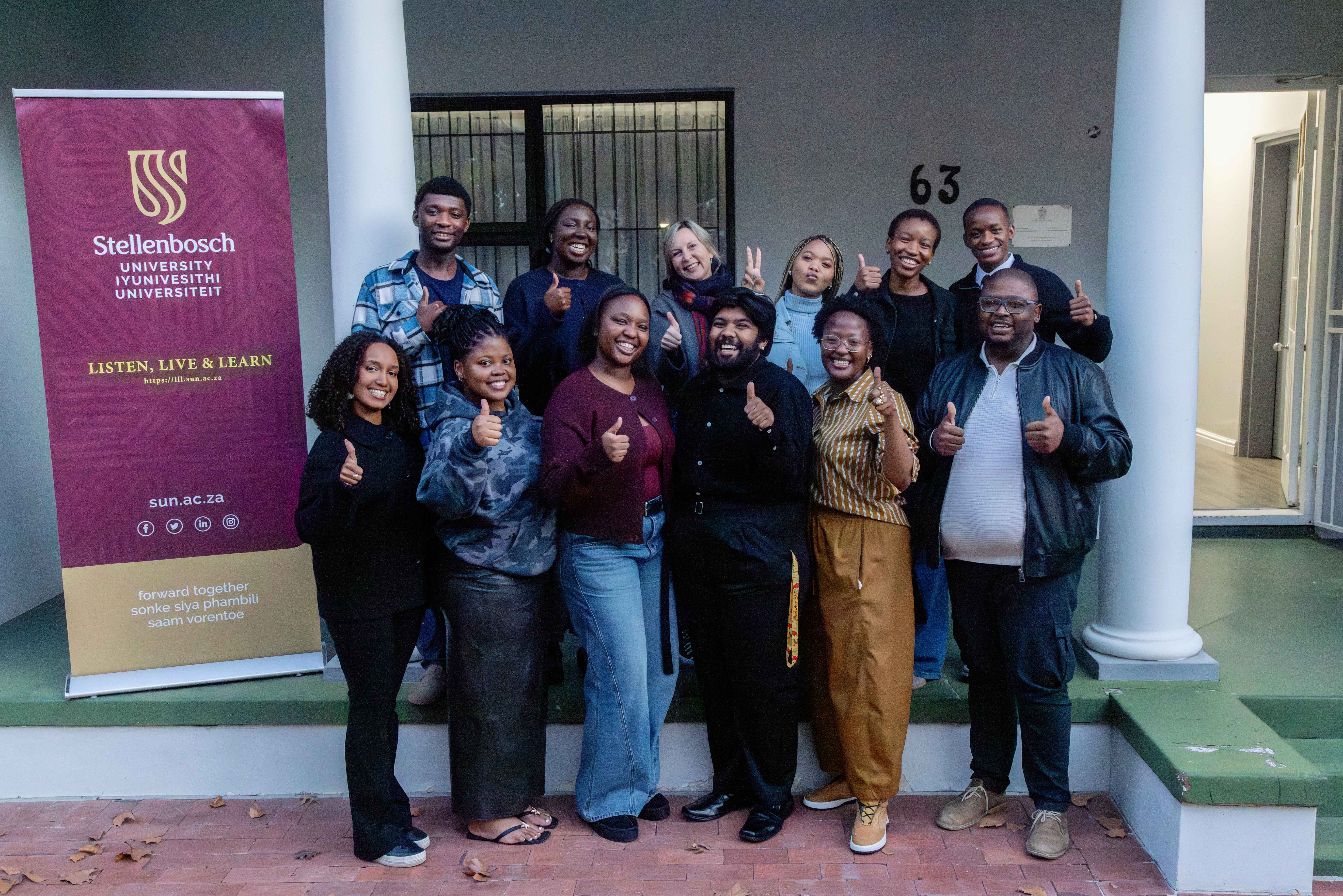 Group of LLL students in front of house